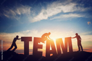 People connect letters to compose the team word. Teamwork concept